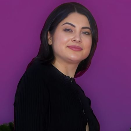 Brooke Reyna is posing for a picture in a purple background.